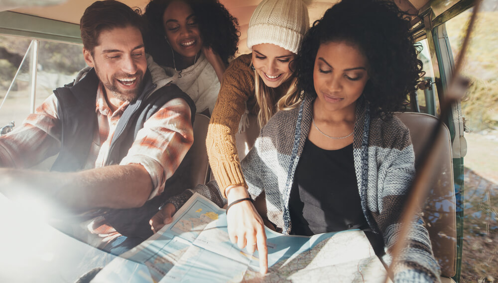 A group mapping out their route to towns on the Washington Coast.