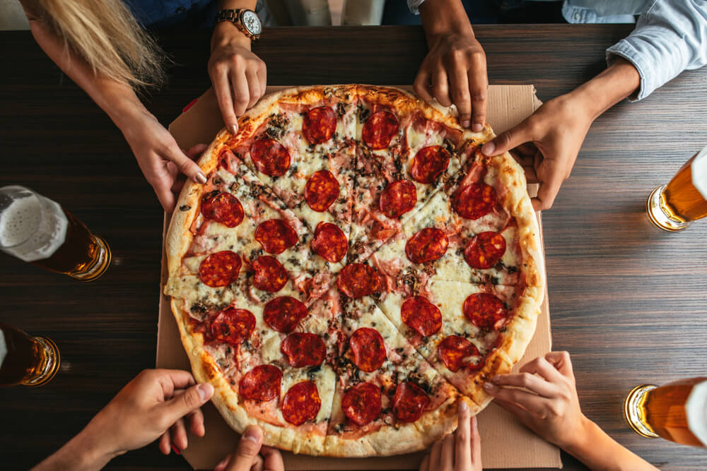 A group eating pizza from an Ocean Shores restaurant.