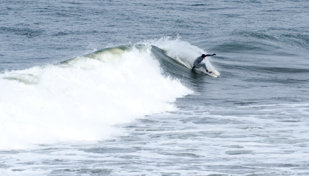 A person enjoying the surf conditions in Ocean Shores, Washington.