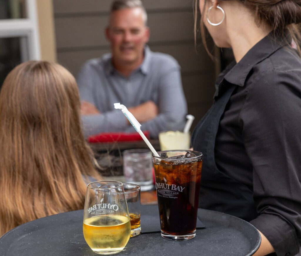 A server bringing drinks to guests at one of the best places to eat in Ocean Shores.