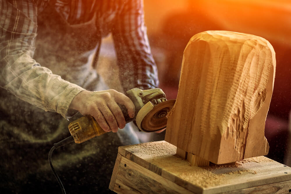 A woodworker working on a piece for the Sand and Sawdust festival.
