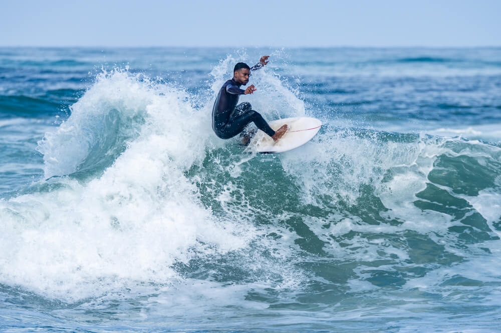 A man surfing, one of the top Ocean Shores tourist activities.