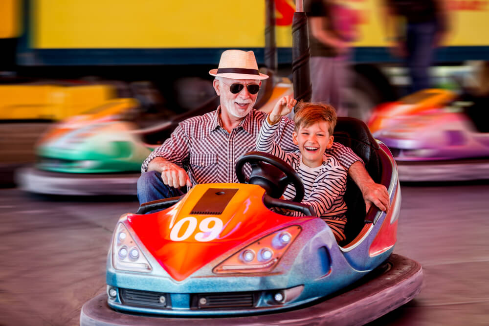 A man and child riding bumper cars on a Washington spring break vacation in Ocean Shores.