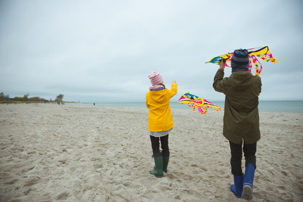 People flying kites on the beach in fall in Ocean Shores, Washington.